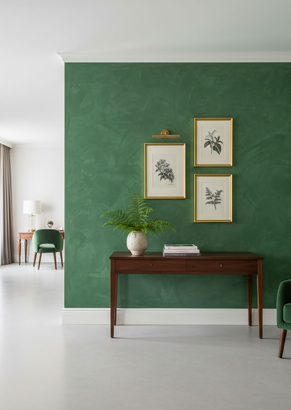 Wohnzimmer mit grüner Paterra Wand, zwei gerahmten Bildern, einem Holztisch mit Pflanze, grüner Sessel und Stehlampe.