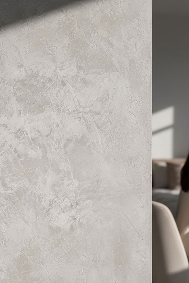 glaMUR W 123 Classic mit einem Bett im Hintergrund; die Wand im Vordergrund ist strukturiert und von Licht und Schatten durchzogen.