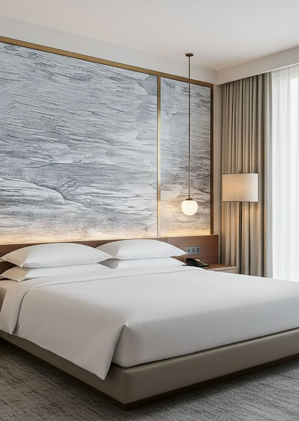 Modernes Schlafzimmer mit einem großen Bett, zwei Nachttischen, hängenden Lampen, einem großen Fenster mit Vorhängen und einer Wand mit Effektspachtel in Marmoroptik.